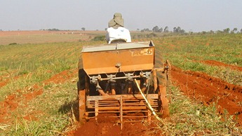 Applying fertilizer in preparation for planting.